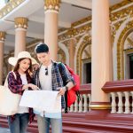Young backpacker couple tour in beautiful temple
